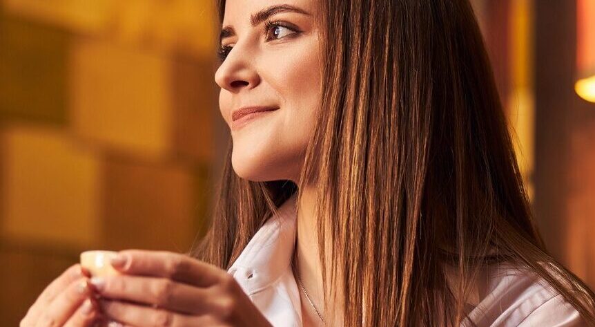 Charming young woman drinking tea in cafe